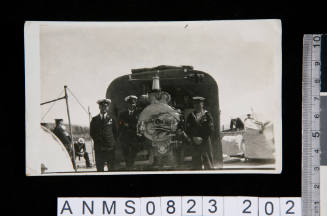 Crew beside a ship's 6-inch gun