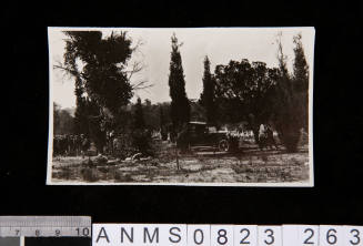 Silver gelatin photograph of funeral car at gravesite during funeral ceremony