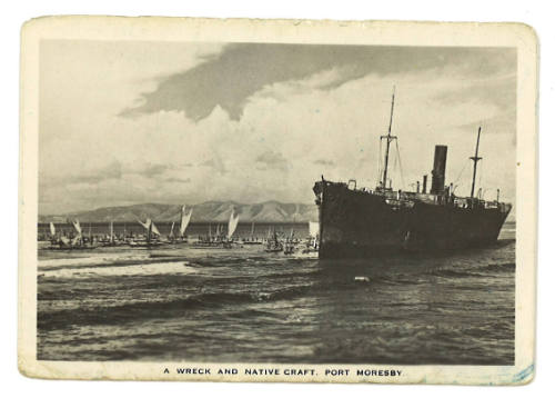 Souvenir photograph of a wrecked ship and native vessels at Port Moresby