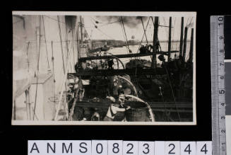 Postcard of port with crew loading docked vessel