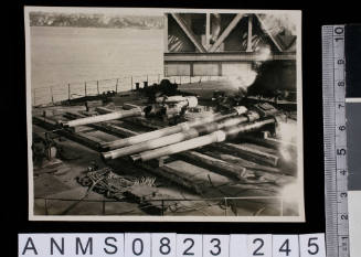 Silver gelatin photograph featuring four torpedo's on deck of vessel
