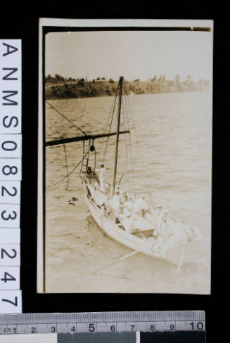 Postcard featuring group of sailors leaving their vessel in small craft