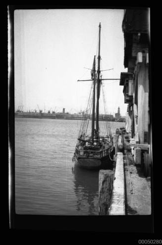 Stern view of a moored two-masted sailing vessel