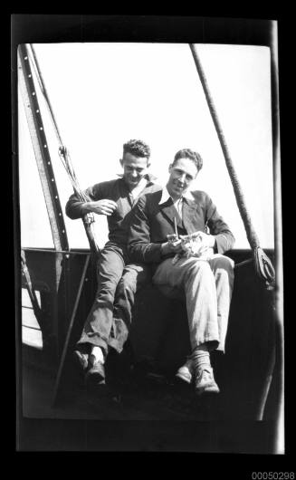 Posing with a cat on a ship's deck