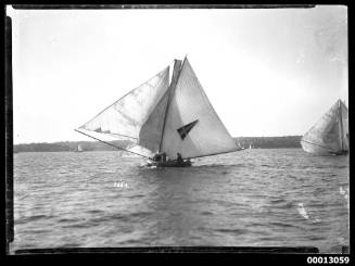 Yacht under sail on Sydney Harbour with a pennant emblem on the mainsail