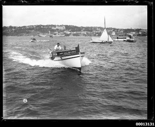 Speedboat displaying the number '38' underway on Sydney Harbour