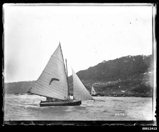 possibly a 16'-foot skiff featuring a boomerang emblem sailing near bradleys head , Sydney Harbour