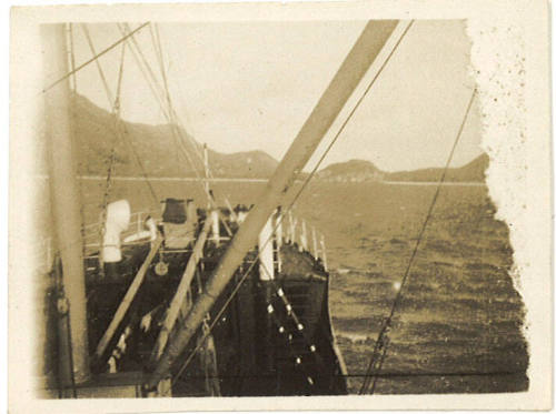 Photograph depicting a view of islands from the bow of a vessel