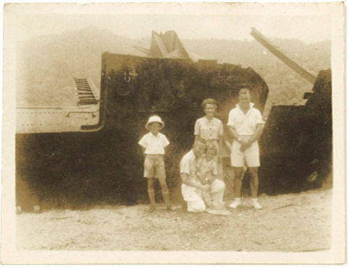 Photograph depicting a group of people in front of an old hull