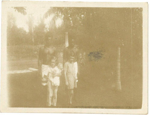 Photograph depicting two children and two men