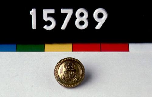 Brass button from the white tunic of Commander Geoffrey Haggard