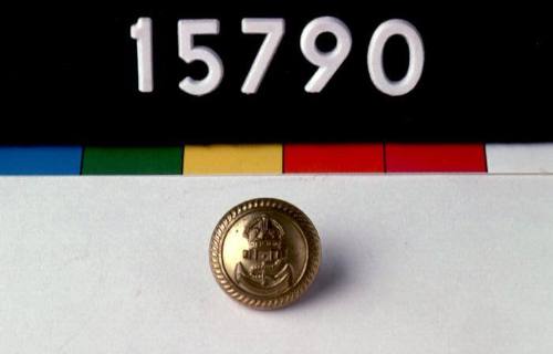 Brass button from the white tunic of Commander Geoffrey Haggard