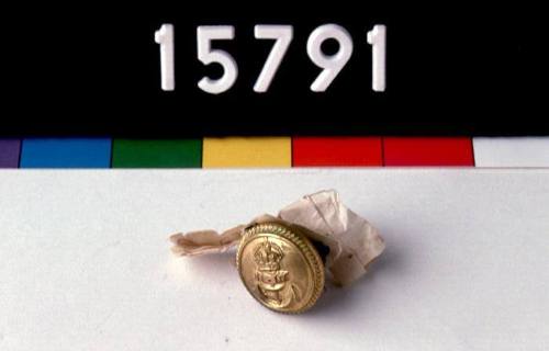 Brass button from the white tunic of Commander Geoffrey Haggard