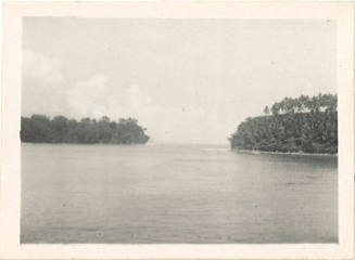 Photograph depicting a channel of water between two tropical islands