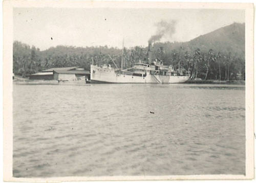 Photograph depicting a vessel moored at tropical island