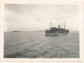 Photograph depicting a vessel sailing near islands