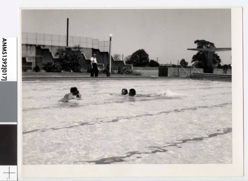 Two men in the pool at St Josephus College having their photograph taken