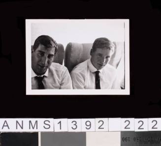 Terry Buck and John O'Brien in an aeroplane en route to the 1964 Tokyo Olympic Games