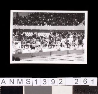Male swimmers behind the pool's blocks at the 1964 Tokyo Olympic Games
