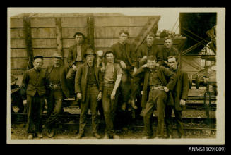 Photographic postcard of a group of male rail workers