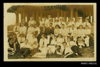 Photographic postcard of a large group of men and women possibly at a picnic shelter at Shark Island, Sydney