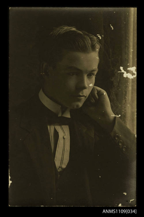 Photographic postcard of a young man formally dressed