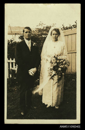 Photographic postcard of a young bride and bridegroom