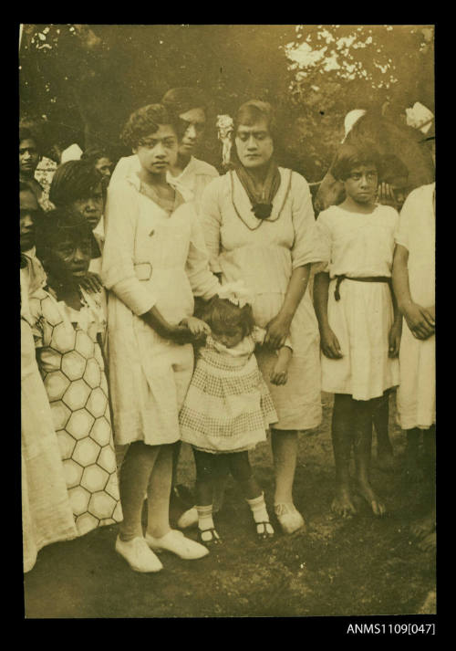 Photograph of a group of Pacific Islander women and children wearing white dresses