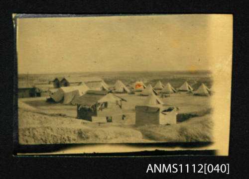 Camp of tents and temporary structures in the desert (Palestine)