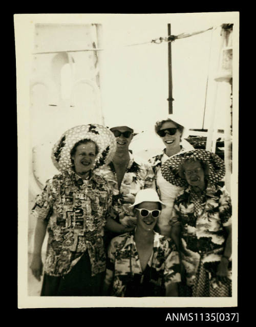 Group of people wearing loud shirts and cane hats