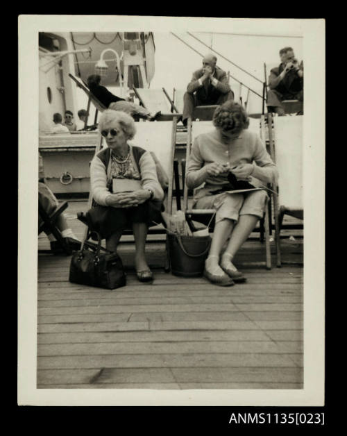 Gladys Gill knitting, seated on a deck chair on the STRATHMORE