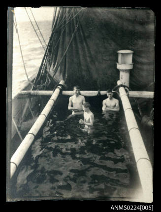 A ships swimming pool made of tarpaulin suspended between heavy poles