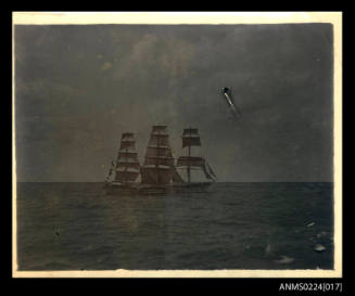 Indistinct photograph at centre, three masted, square rigged sailing ship at sea, starboard view