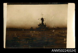 Photograph centre Indistinct bow of large warship, possibly battleship