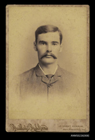 Portrait of a man with fine grained buttoned coat to neck, tie moustache, dark hair Captain mckilliam
