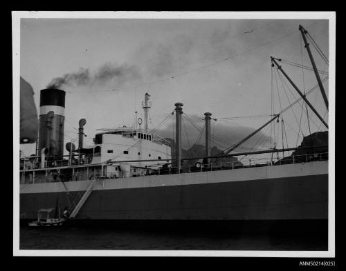 Starboard view of midships of freighter, possibly CITY OF SYDNEY, in harbour