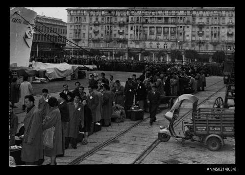 Migrants standing in line to embark CASTEL VERDE at a wharf in Trieste, Italy before departing for Australia