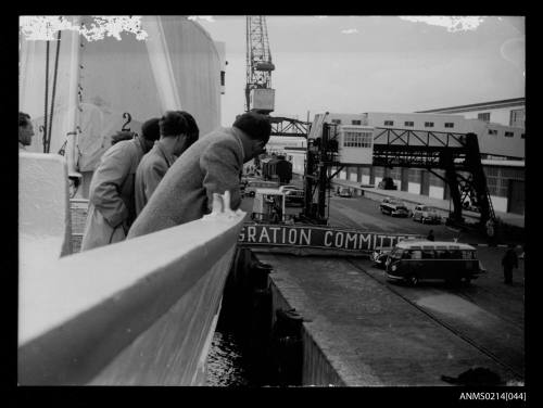 Migrants looking down at Columbus Pier, note the embarkation gangway which is used during wet or unfavourable weather