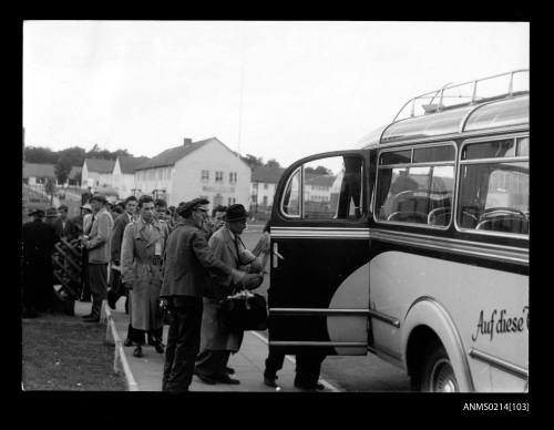 German migrants boarding buses at camp Lesum, Bremen after processing for migration