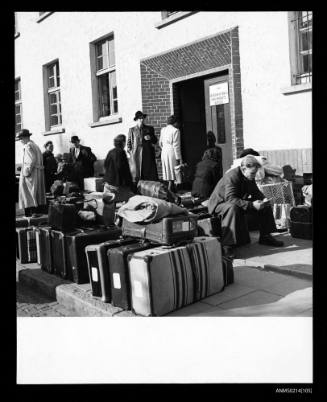 Migrants waiting near their luggage at the IMO documentation office, Uberseeheim, Brem