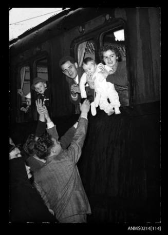 A family farewell from a train carriage