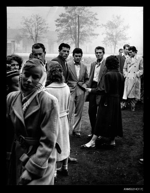 Group of men and women standing near a park