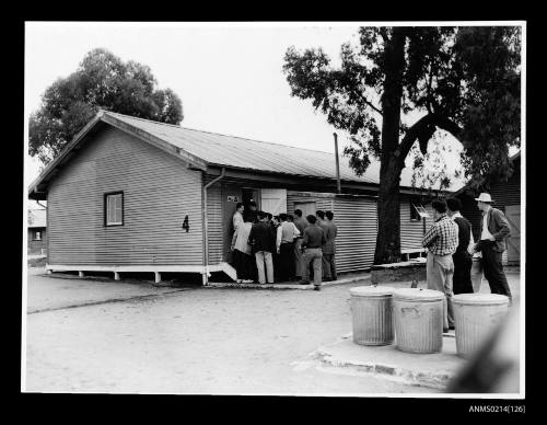 Migrants lining up for a meal at the entrance to the mess at Bonegilla reception centre