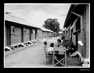 Corrugated iron sheds with children outside