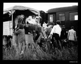 Refugees transferring from trucks to train transport outside Osijek railway station