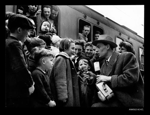 Gundomar Eibegger, of Radio Austria, records on tape the impressions of a group of children, about to leave Salzburg Austria for Australia