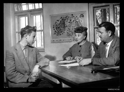 Mervin Stratton (right), the Australian interviewing officer, talks over the opportunities Australia has to offer to a young man like lasle Zentay. 17 year old Zentay was a gymnasium student in Hungary before he fled to Yugoslavia