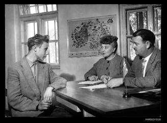 Mervin Stratton (right), the Australian interviewing officer, talks over the opportunities Australia has to offer to a young man like lasle Zentay. 17 year old Zentay was a gymnasium student in Hungary before he fled to Yugoslavia