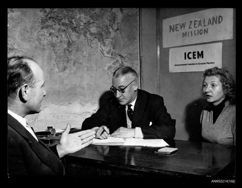 Man and woman interviewing a man at a desk