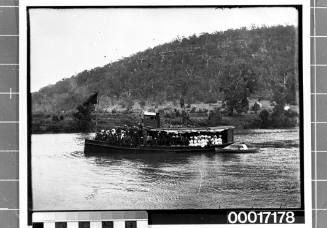 Crowded single deck ferry underway